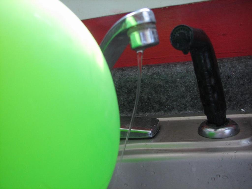 A balloon is rubbed all over with wool. The balloon will now attract the water because A. The balloon and the water are magnets B.