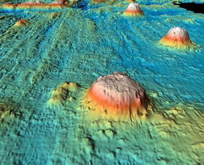 Guyots Flat topped seamounts The peak/top of the Seamount has been removed/eroded as a result of wave action The sinking of the oceanic crust lowered the tops of the Guyots below the surface Atolls