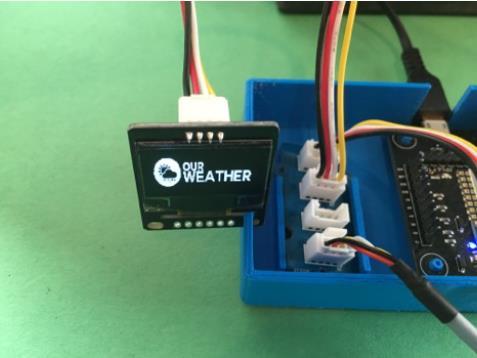 Step 2: Plug in the Wall unit of the 5V Power Supply (A) into a 110V AC outlet. You will then see the OurWeather logo on the OLED Display (B).