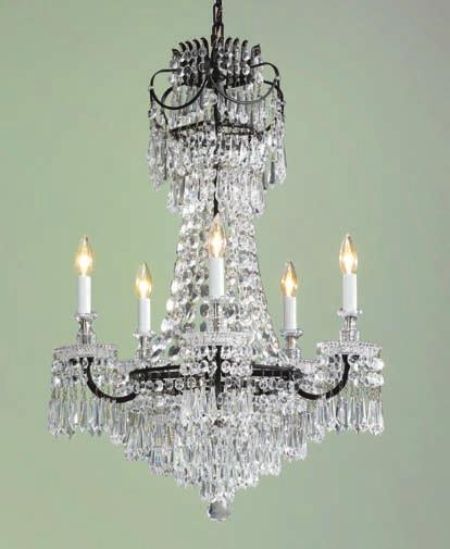 An opulent mirrored sconce features exquisite hand-cut glass.