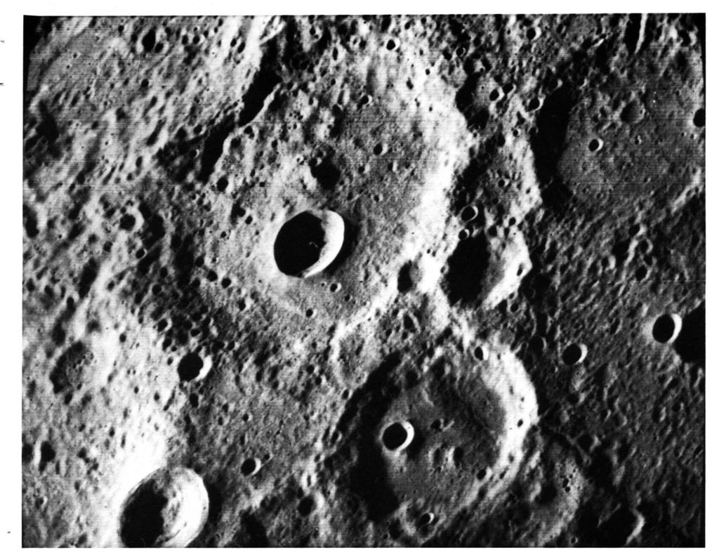 A fresh new crater in the center of an older crater basin is shown in this picture of the surface of Mercury taken 29 March by the Mariner 10.