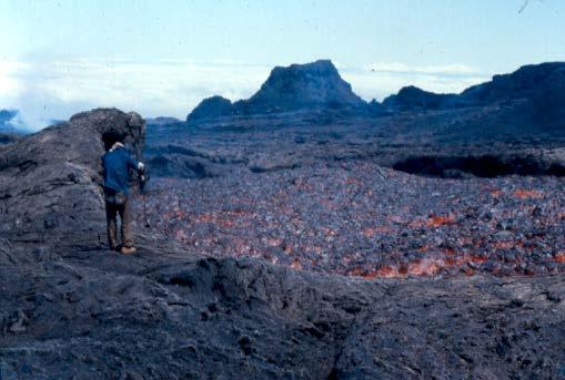 Volcanologist on edge of lava