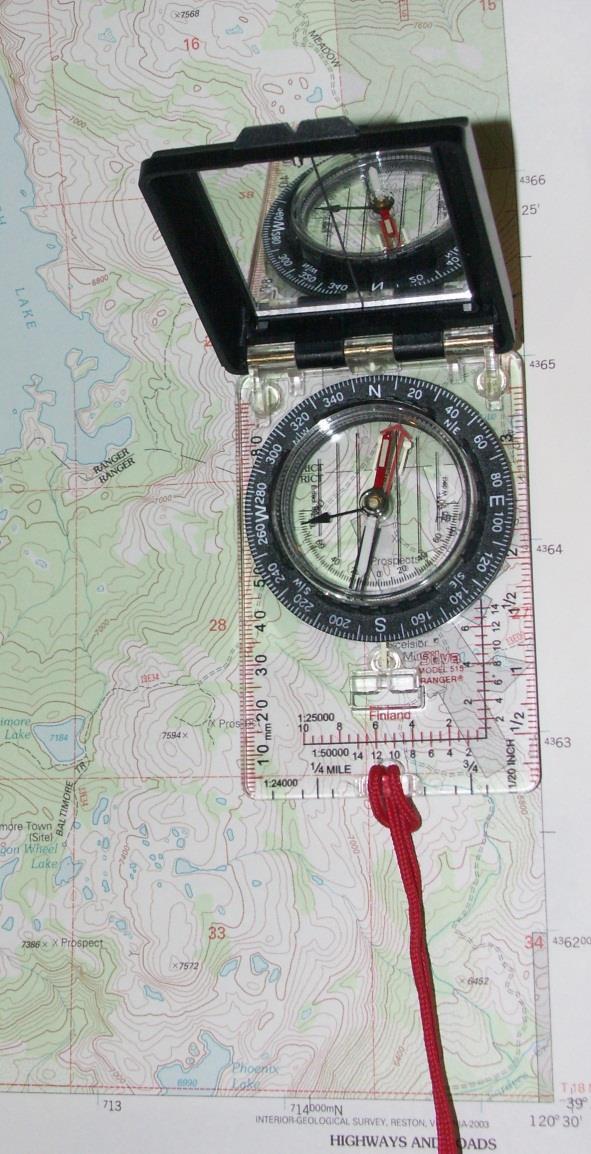 Turn bezel to set North at index mark Align baseplate of compass