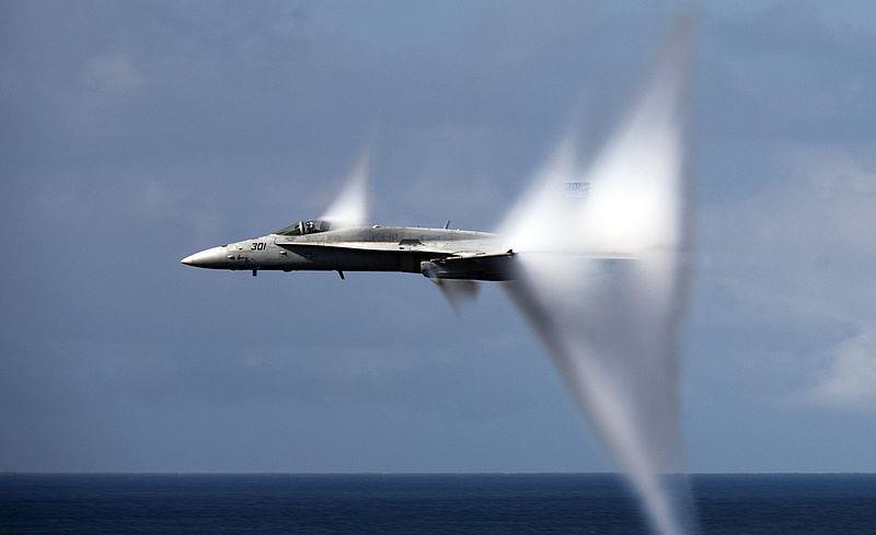 Water in the atmosphere condenses because of the air pressure drop and forms cloud around the jet traveling