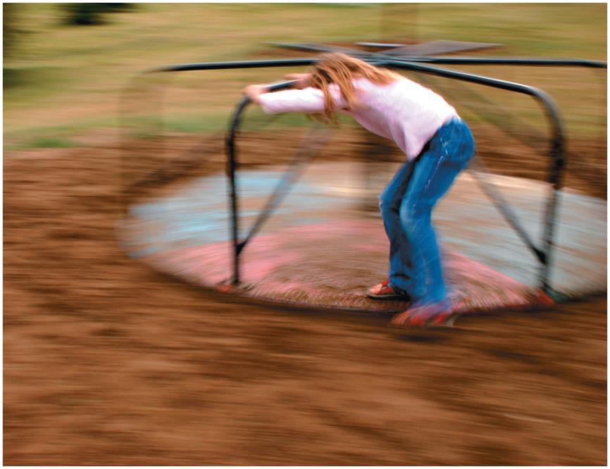 Chapter 7 Preview Looking Ahead: Rotational Dynamics The girl pushes on the outside edge of the merry-go-round, gradually