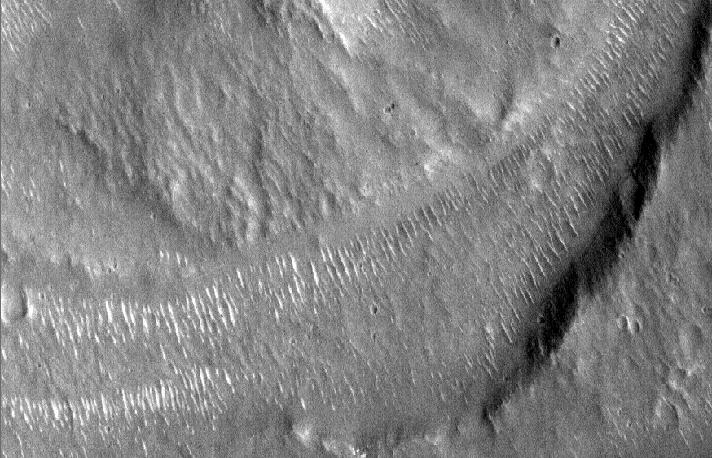 Observations of images S09-2300 and S06-00101, examples are above and below, have led to the conclusion that wind has been, and still is, a major contributor to the erosion of many craters in these