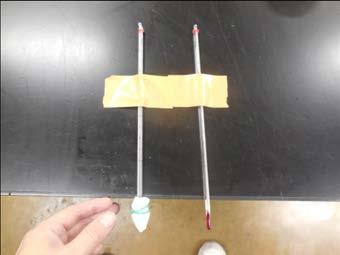 Put a wet gauze around the end of one thermometer using the elastic