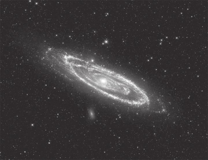 6 (a) The image shows the Andromeda galaxy. Stars and galaxies (i) Complete the sentence by putting a cross ( ) in the box next to your answer.