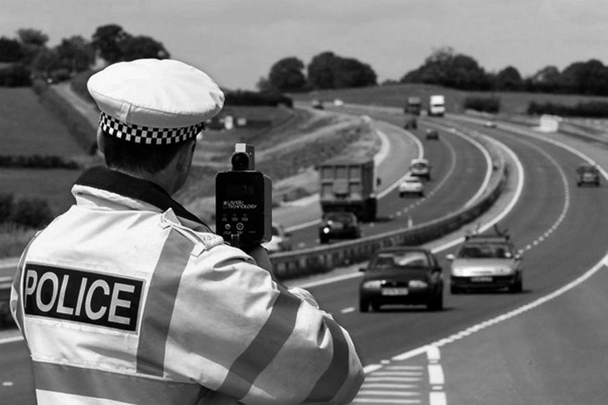 0. A police officer is conducting vehicle speed checks using a radar based monitoring device as shown in Figure 0.