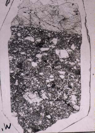 Figure 7: Thin section 61016,220 showing boundary of melt rock breccia and anorthosite cap (scale 20 mm).