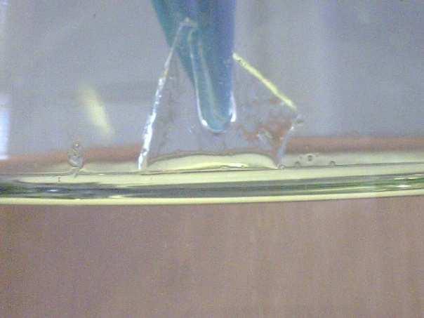 Photo A shows a small piece of Pyrex glass not immersed in a liquid.