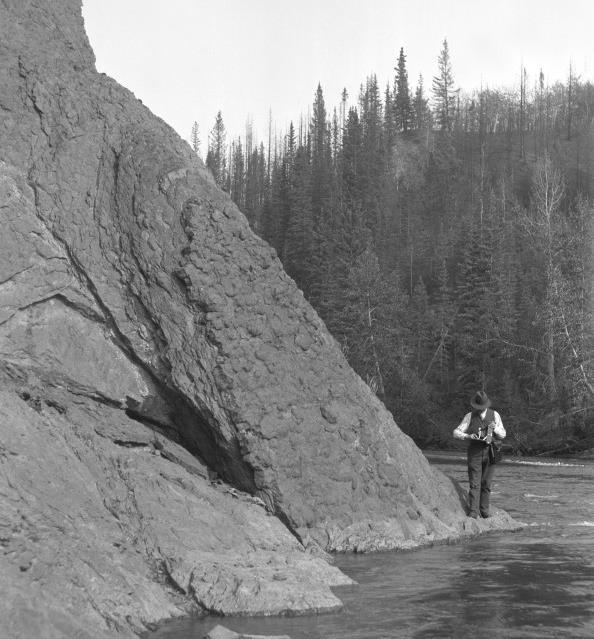Figure 2. John Allan and photographic equipment along the Sheep River in the summer of 1915 (UAA 77-84-14). John Allan realized that a lot of gas was wasted in Turner Valley (Figure 4).