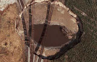 Missouri-Pacific railroad tracks suspended 6 meters in the air. The volume of the crater was estimated at 70,000 cubic meters.