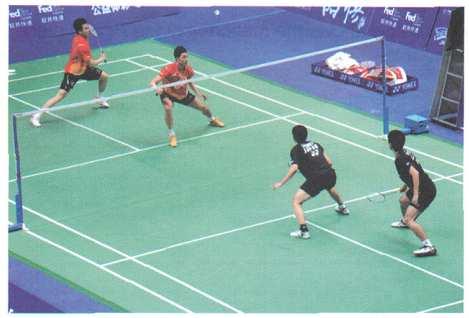 (d) The photograph below shows four people playing badminton: During a badminton match a shuttlecock is hit at a height of 2.4 m above ground level.