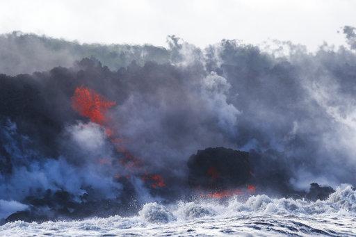 the first major injury. (AP Photo/Jae C. People take pictures as lava enters the ocean, generating plumes of steam near Pahoa, Hawaii Sunday, May 20, 2018.