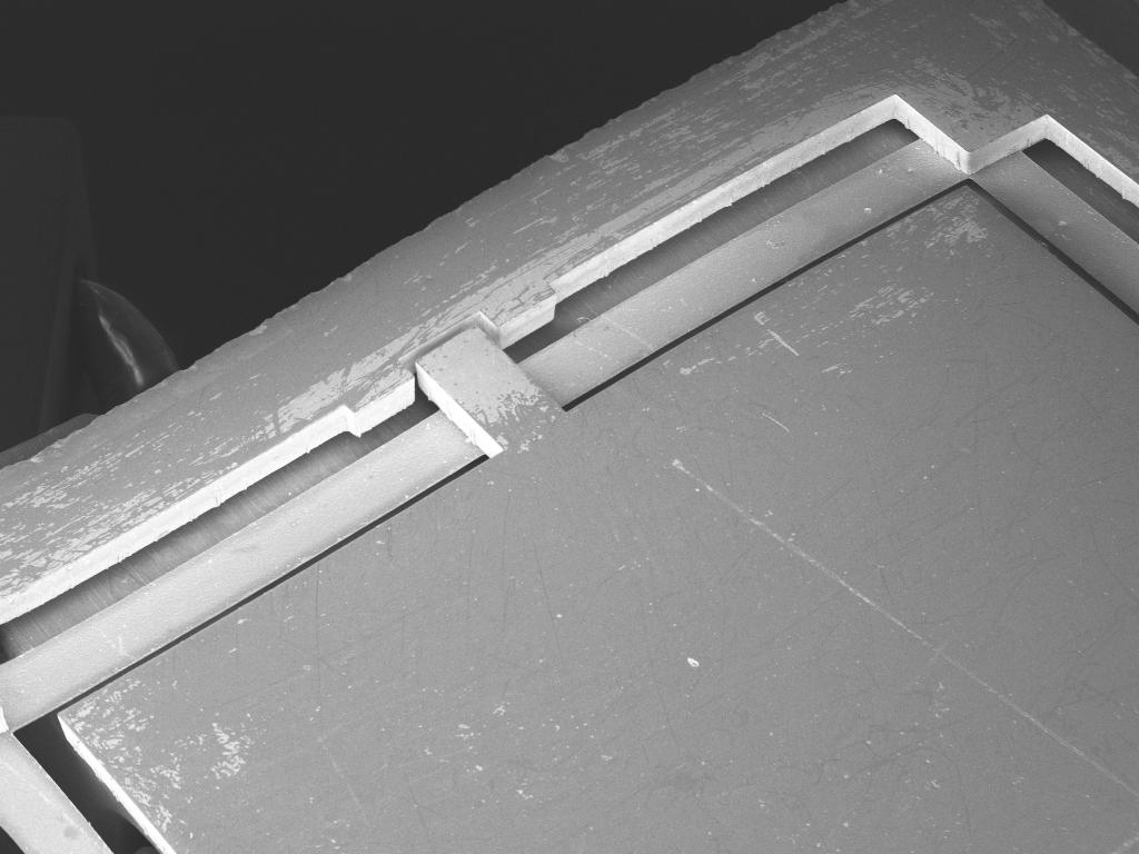 Fig. 4: Detail of middle wafer showing suspension strips and anchor points. Fig.