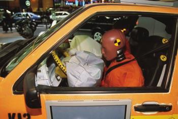 1.5 Figure 6 As the test vehicle shown crashes into a barrier, the airbag being researched expands rapidly and prevents the dummy s head from striking the windshield or steering wheel.