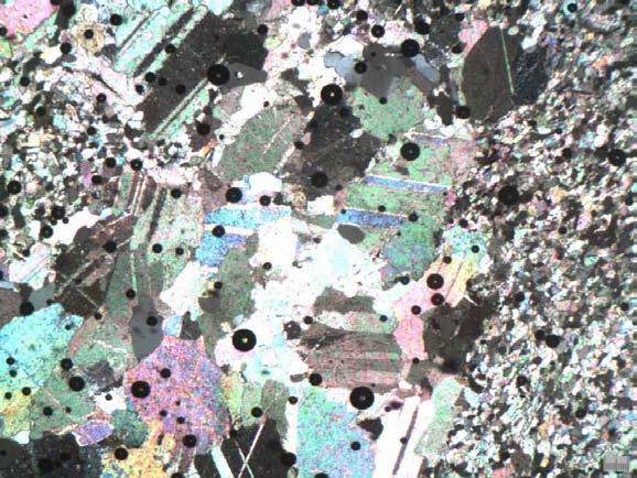 quartz. Fig. 3 Photomicrograph of finely crystalline, dolo-sparstone (subsample X, section 4) showing a mosaic of dolospar and muscovite, and a thick vein of giant calcite spars.