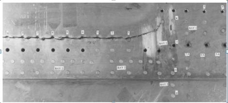 International OPEN ACCESS Journal Of Modern Engineering Research (IJMER) Determination of Stress Intensity Factor for a Crack Emanating From a Rivet Hole and Approaching Another in Curved Sheet