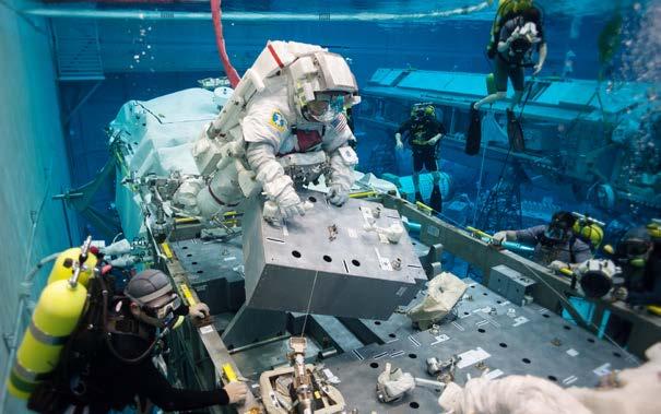 Astronauts also spend up to seven hours in a space suit while working underwater. They work on life-size models of space vehicles in a huge 6.2 million-gallon (23.