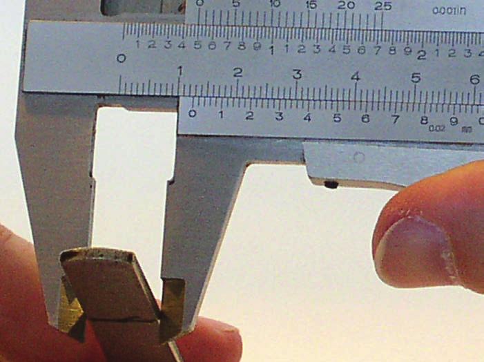 Reading a Vernier Caliper Figure 9 Now when we examine the graduations on the vernier, we see the graduation at number 6 is in perfect alignment. So the measurement is 12.6 millimeters.