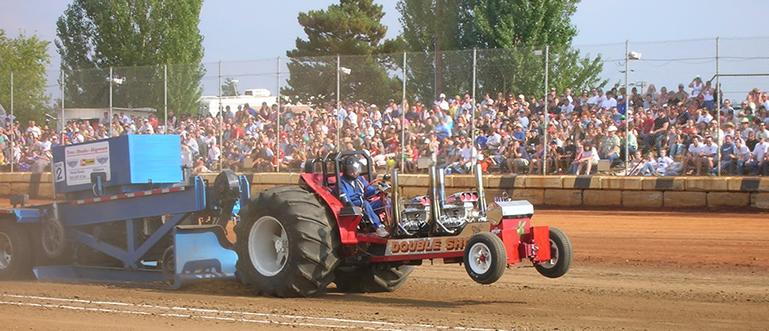 Question 14 - write out the appropriate equation and show all working The picture above shows a tractor pull competition.