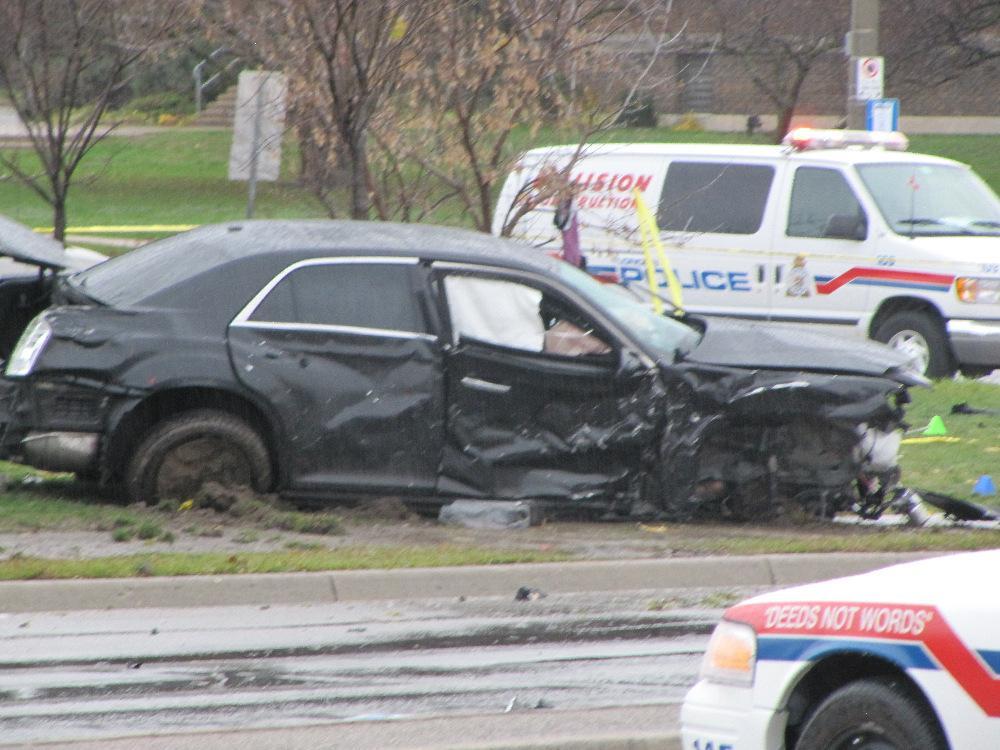 View showing significant damage to a black Chrysler 300 The view below