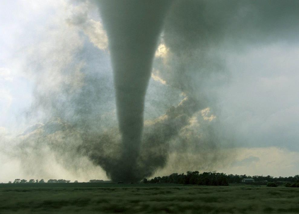 Tornado A tornado (aka twister) is a violently rotating column of air (wind vortex) that is