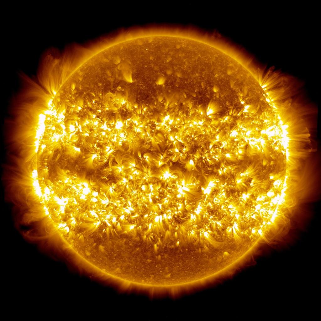 You'd be correct in thinking that fusing ~4 10 38 protons-per-second gives off a tremendous amount of energy, but remember that nuclear fusion occurs in a huge region of the sun: about the innermost