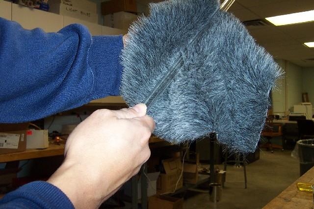 sphere. Hold it by one end. Pick up the gray fake fur in the other hand and wrap it around the rod, covering as much of it as you can.