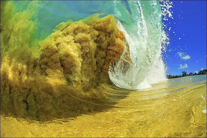 How do waves break in shallow water?
