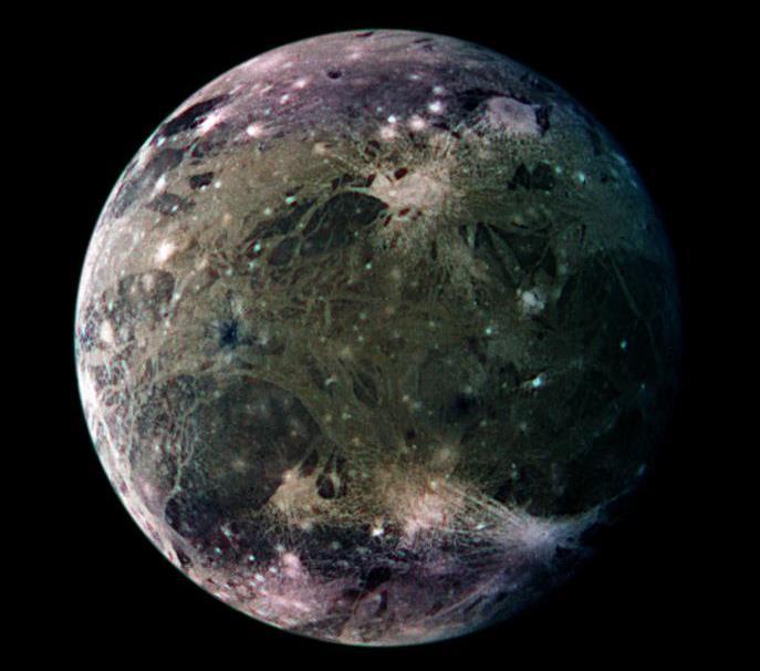 Ganymede in enhanced color Bright, grooved terrain and dark, furrowed