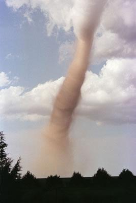 Tornado A tornado is a violently rotating column of air that usually touches the ground A rotating updraft of air in a