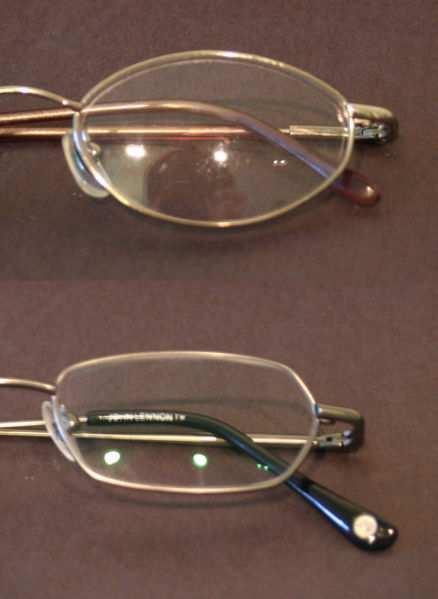 Slide 77 / 108 Interference by Lens Coating The glasses on the top do not have the anti glare coating and the reflection of the person standing above the glasses is seen.