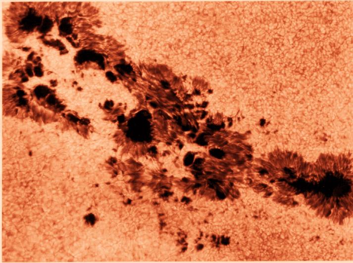 They are only dark in a relative sense; a sunspot removed from the bright background of the Sun would glow quite brightly. 1.