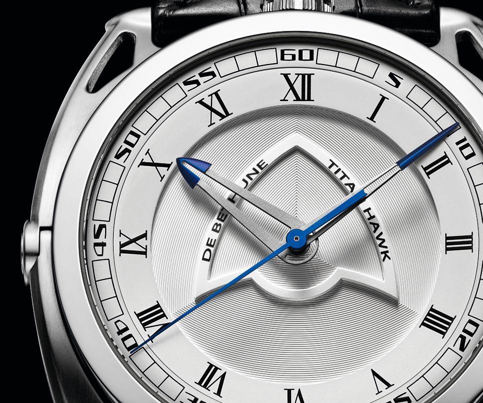 Silver-toned microlight dial centre surrounded by a chapter ring with Roman numerals and minute circle with Arabic