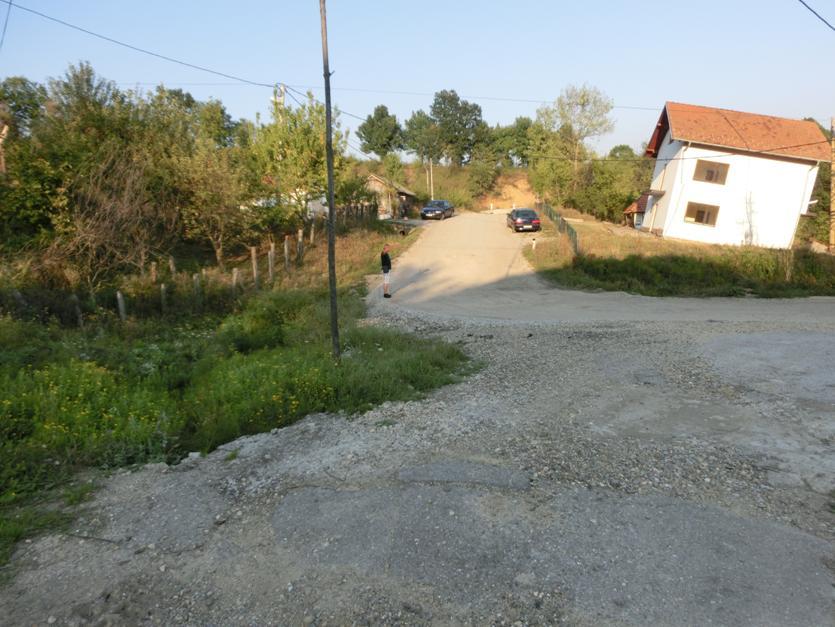 Deformations were present along the road in the middle section of the landslide. This road runs approximately perpendicular to the direction of the landslide movement (Photo 3).