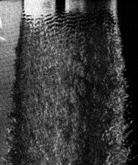 Atomization - Wave breakup model Taylor & Hoyt, 1983 High speed photograph of water jet close to nozzle exit (at top) in the second wind-induced breakup regime showing surface wave instability growth