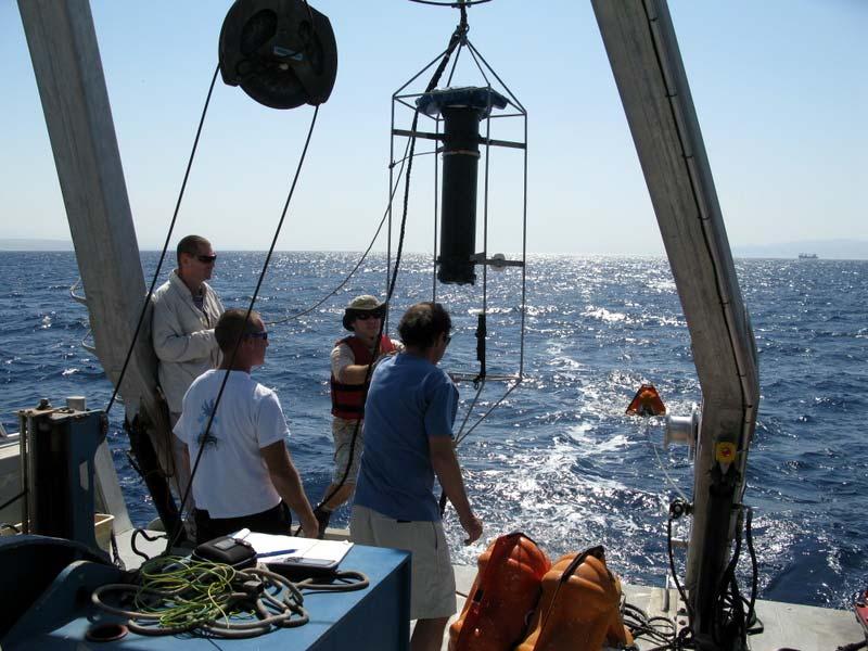 In the foreground, Igal Berenstein (left) and Eli Biton (right) prepare to move the 15 khz ADCP and additional flotation into position for
