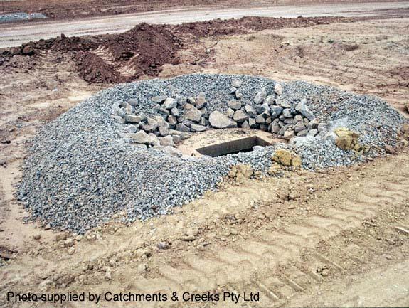 The purpose of the aggregate is to control the rate of flow entering the stormwater inlet (thus allowing the formation of a settling pond around the inlet), and to provide limited filtration of flows