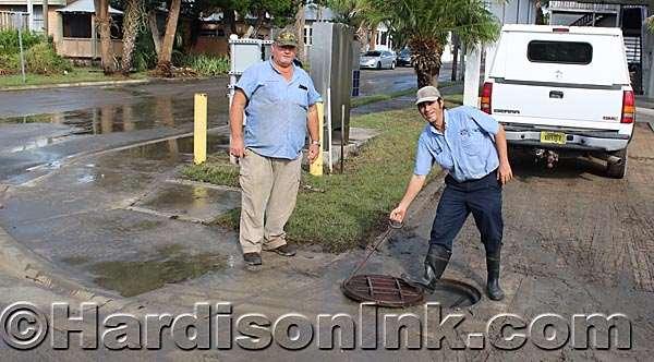 Normalcy returns to coastal Levy and Dixie counties James McCain (left) and Billy Quinn of Cedar Key Water and Sewer Service, check a storm drain pipe. Quinn is replacing the manhole cover here.