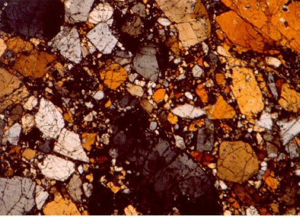 c Figure 4: Photomicrographs of thin section of 72415,25 showing large olivine grains in ground-up olivine matrix. Field of view is 2.5 mm. NASA# S79-27287-27289.