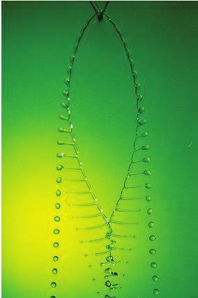 The fluid streams radially outward in a thinning sheet; once the fluid reaches the sheet rim, it is ejected radially in the form of droplets. From G.I. Taylor (1960).