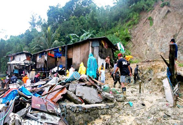 Soldiers and volunteers search for bodies following a landslide