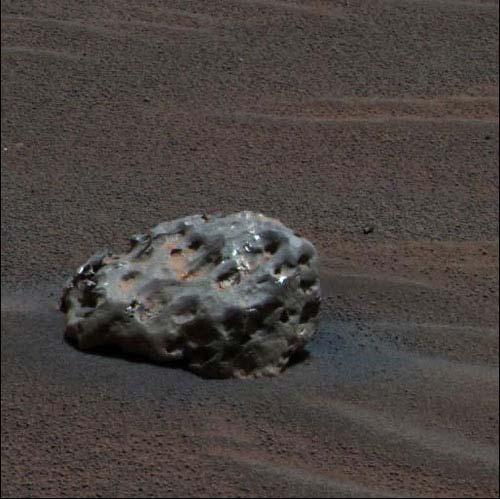 Meteorites can be found on the surface of Mars just as they are found on Earth, but even though the Opportunity Rover covered a minute fraction of the Mars surface, it actually found a meteorite