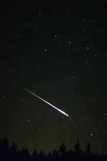 .. A Leonid meteor A meteoroid is a small body made up of dust or debris that travels through the space vacuum. The space vacuum is more commonly referred to as outer space.