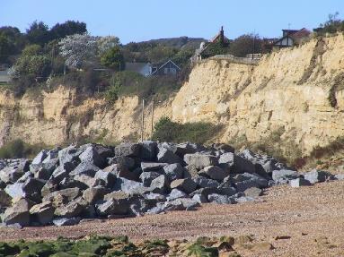 2. Rock buttresses, revetments and rip rap. Waves enter spaces between rocks and multiple reflections absorb wave energy preventing erosion to the coastline.